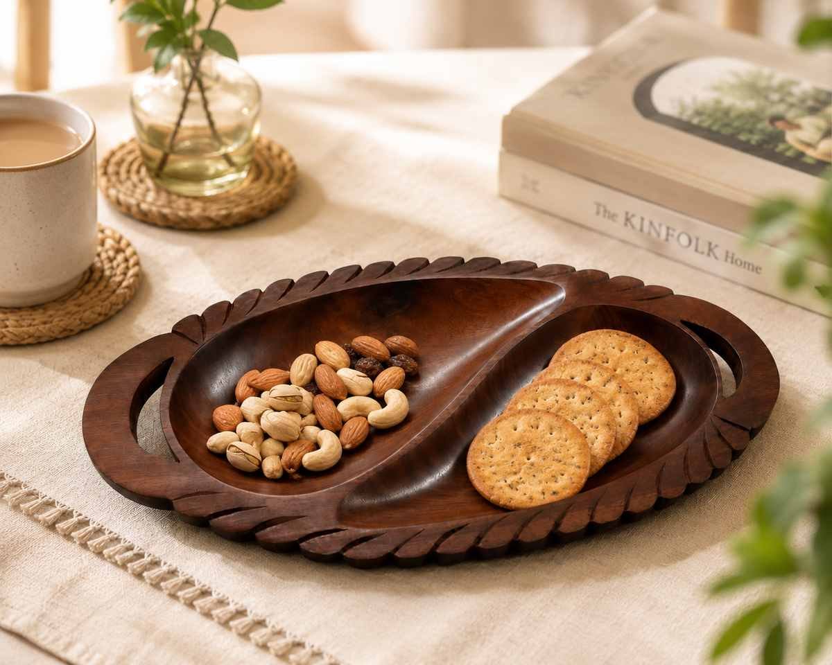 oval wooden serving tray with snacks and dry fruits